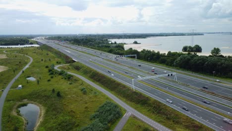 aerial shot of highway at a lake