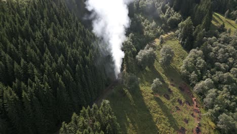 Aerial-Footage-of-Farmers-Burning-Waste-on-a-Path-in-Vik-i-Sogn,-Norway-creating-a-Large-Smoke-Cloud