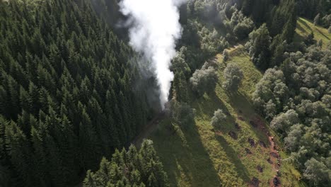 aerial footage of farmers burning waste on a path in vik i sogn, norway creating a large smoke cloud