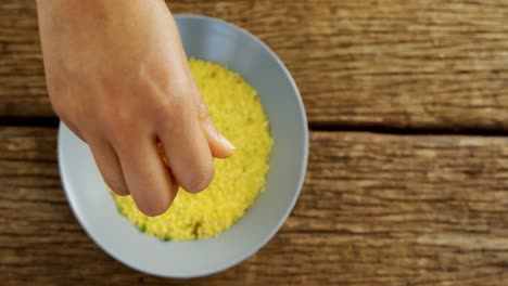 hands pouring rice in a bowl 4k