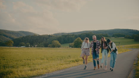 happy friends having fun while walking on footpath