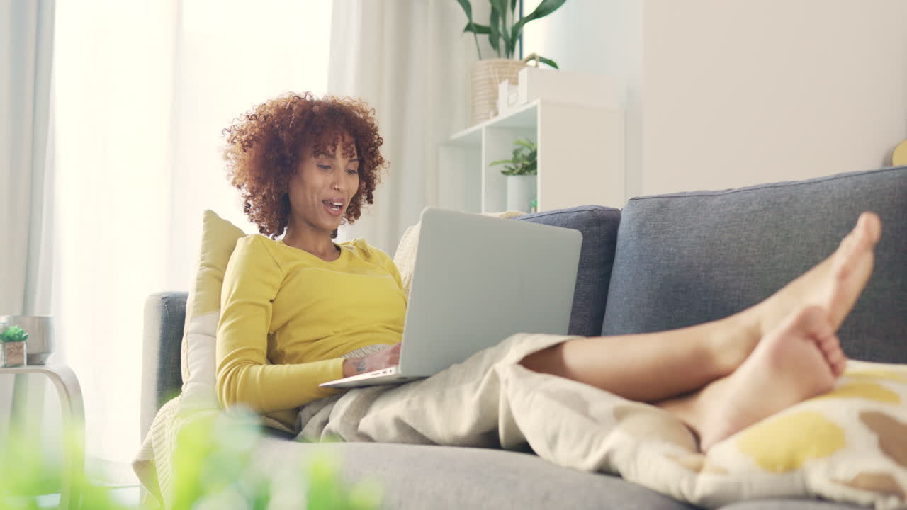 Excited black woman celebrating while using