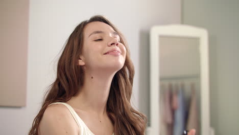 young woman spraying micellar water on face. beauty woman spraying face