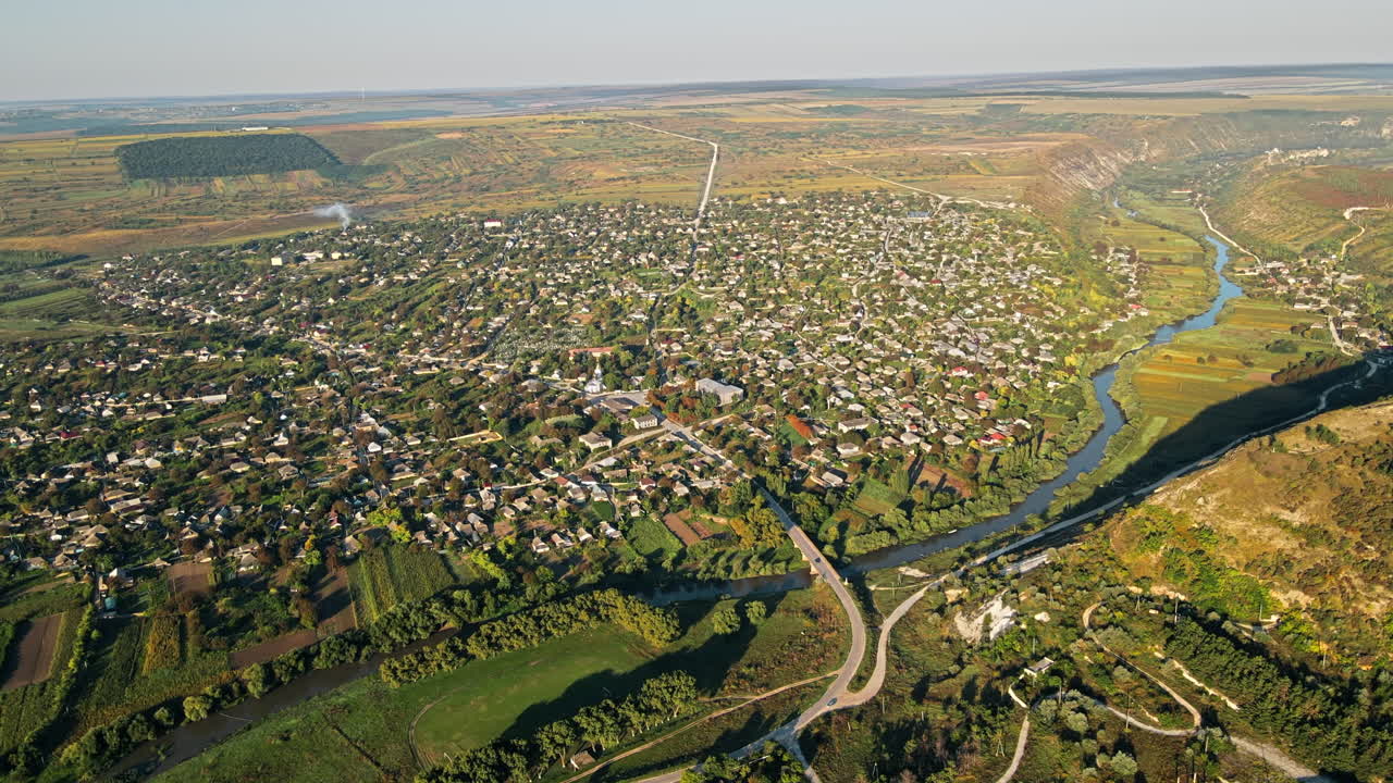 Aerial drone view of a village in Moldova. Valley with river, hills and fields in Moldova