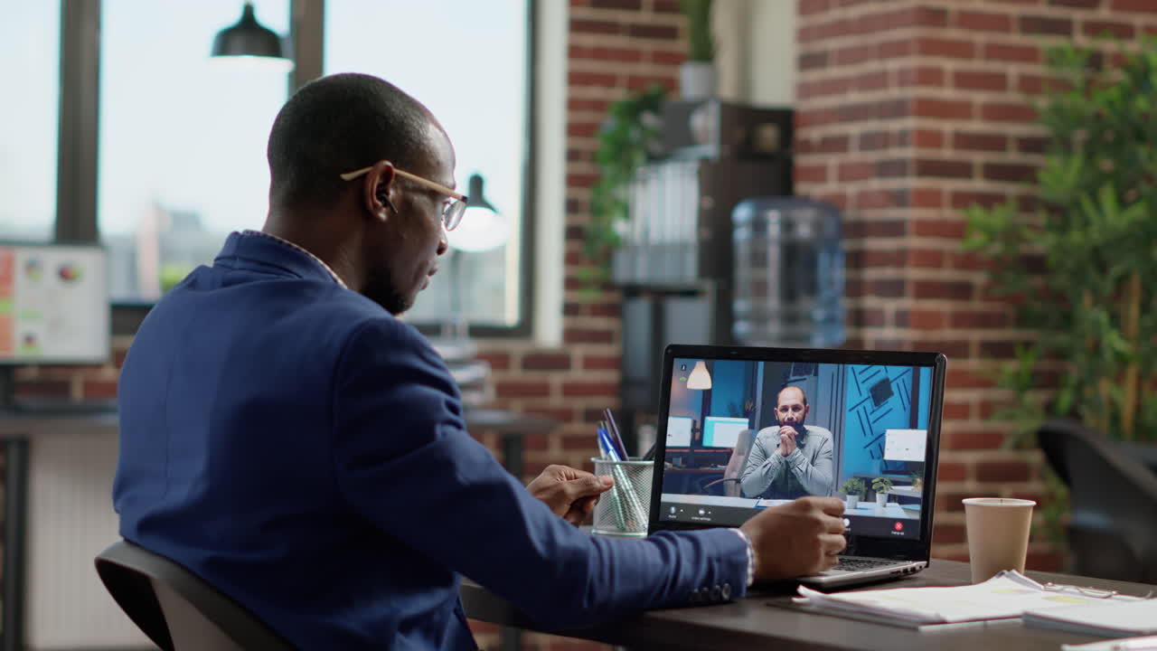 Company employee attending remote videocall meeting with man