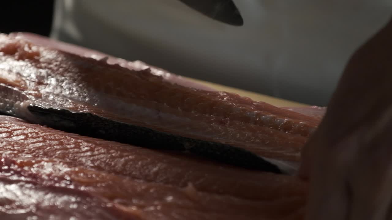 Chef preparing fresh salmon in the kitchen
