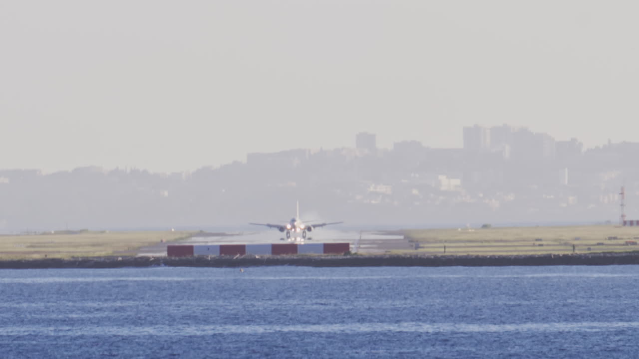 Distant view of airplanes landing at the Nice Cote d'Azur Airport in daylight