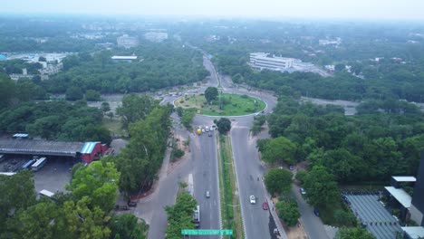 the tribune chowk roundabout surrounded with green trees, tribune newspaper publisher office building in view, chandigarh, drone shot