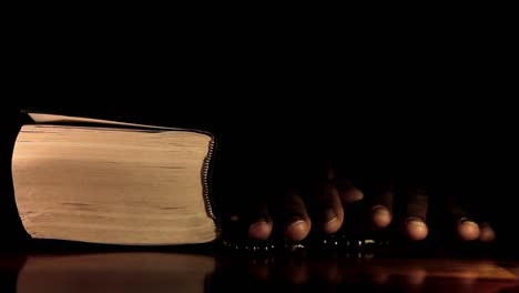 man-praying-to-god-with-hands-together-with-bible-Caribbean-man-praying-with-black-background-stock-video