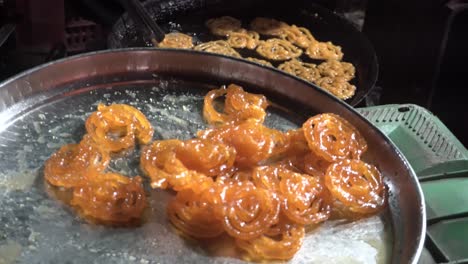 man making indian sweet jalebi closeup view