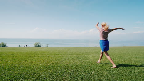 Cheerful-Active-Woman-Is-Walking-On-A-Green-Meadow-Youth-And-Activity