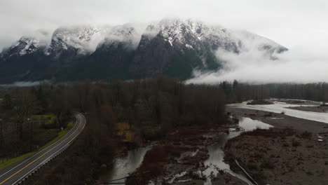 4k drone footage of snowcapped mount si in clouds and fog