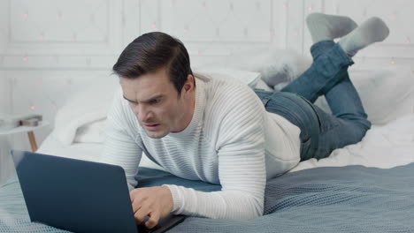 aggressive male professional making evil grin in front of computer.