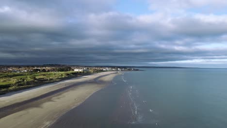Drone Flying over Portmarnock Beach on a Sunny Day.Morning walk on the Beach. Bright and Sunny day