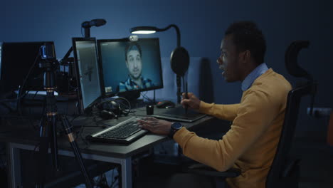man working on a computer at night
