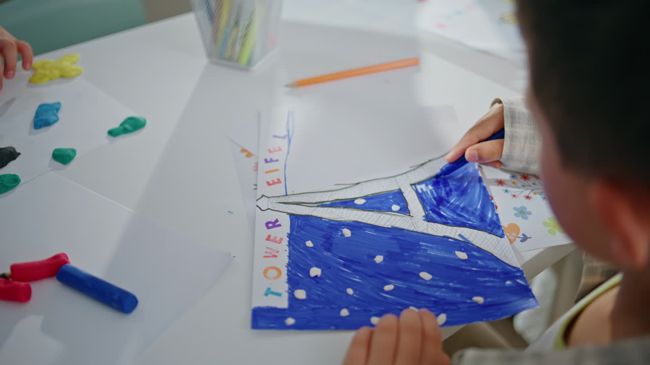 Small kid drawing picture art lesson closeup. Little artist holding felt-tip-pen