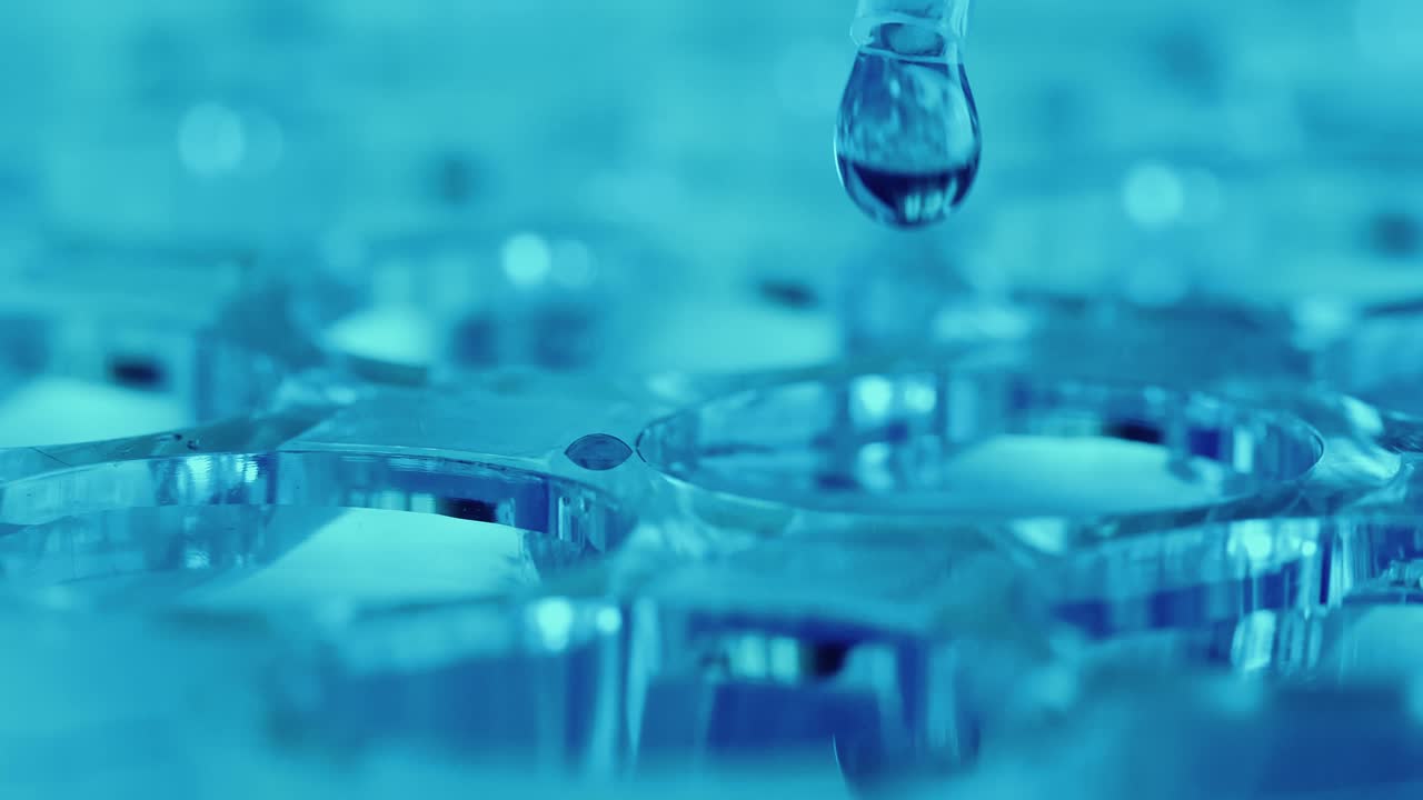 Pipette Filling Well of Microplate with Colorless Liquid in Laboratory