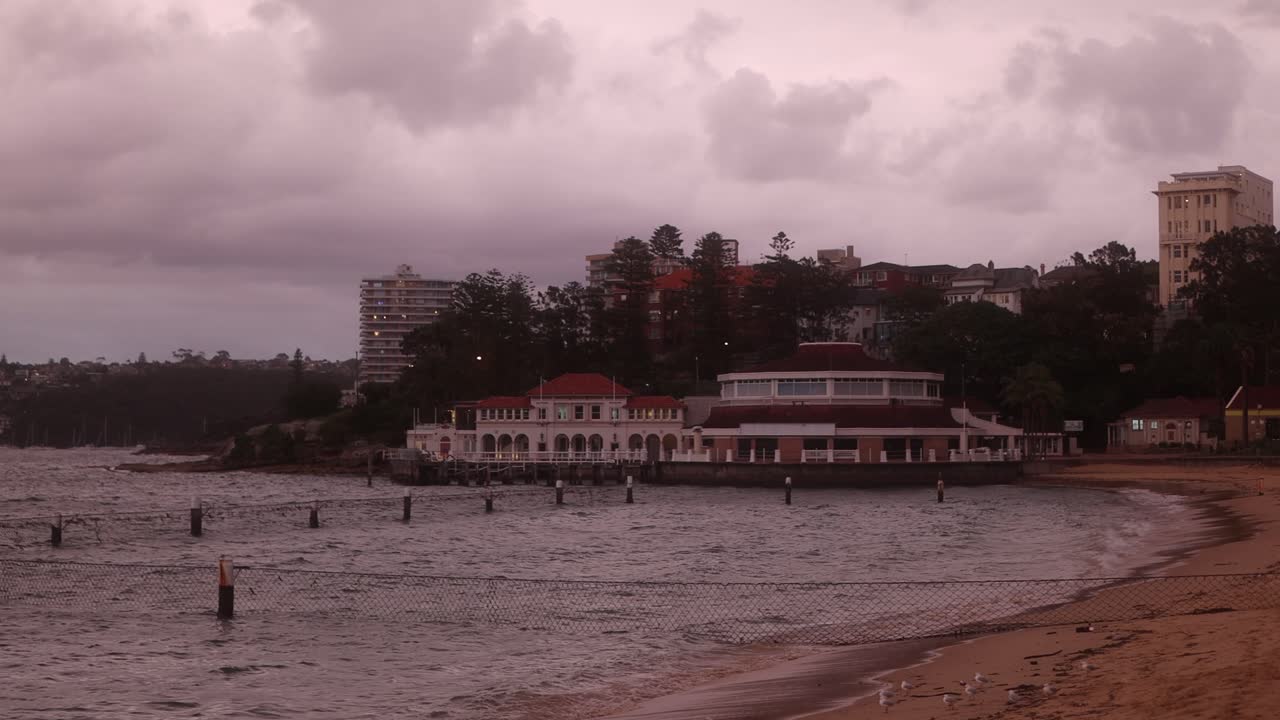 Manly's sea life building amidst a stormy backdrop