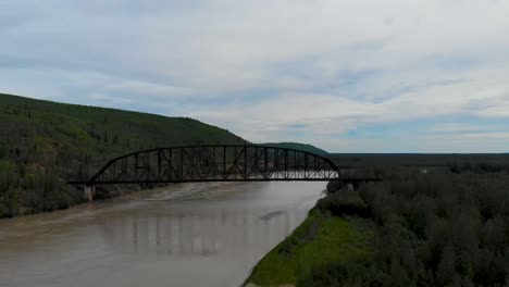 4k drone video of mears memorial steel truss train bridge over the tanana river at nenana, alaska during summer day