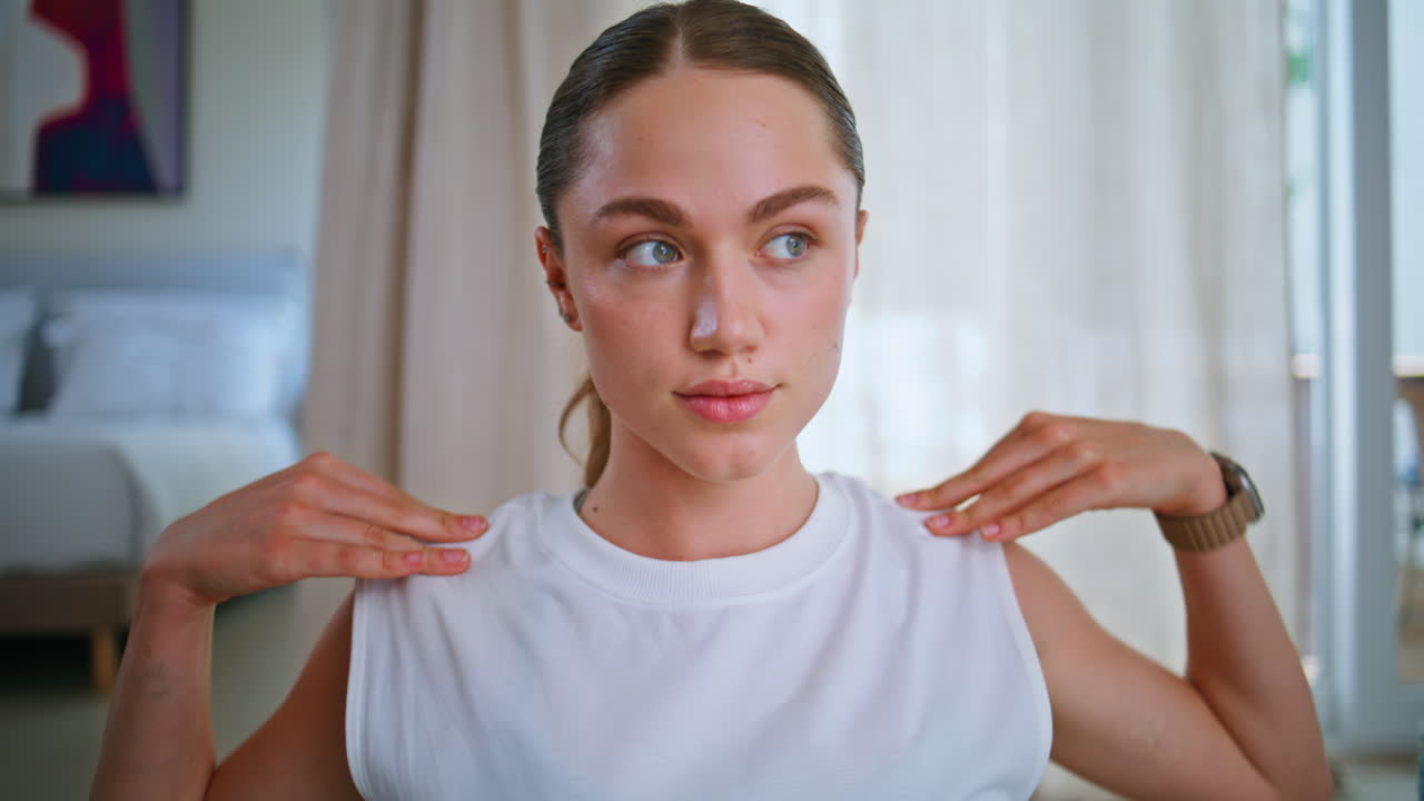 Closeup girl stretching hands at modern apartment. Portrait woman warming up