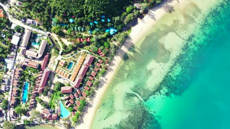 summer holiday resorts on shore of tropical island with white sandy beaches washed by turquoise lagoon in thailand