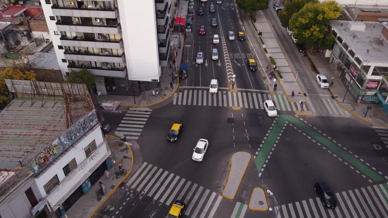 Aerial approaching view of vehicles diverting at intersection at Cordoba Avenue fork in Buenos Aires
