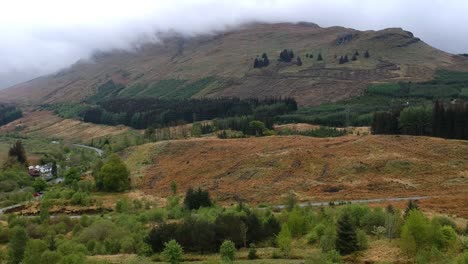 Drone-reveal-shot-of-misty-highland-mountain