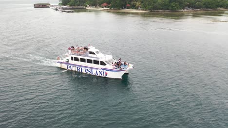 ferry boat with passengers in tropical waters