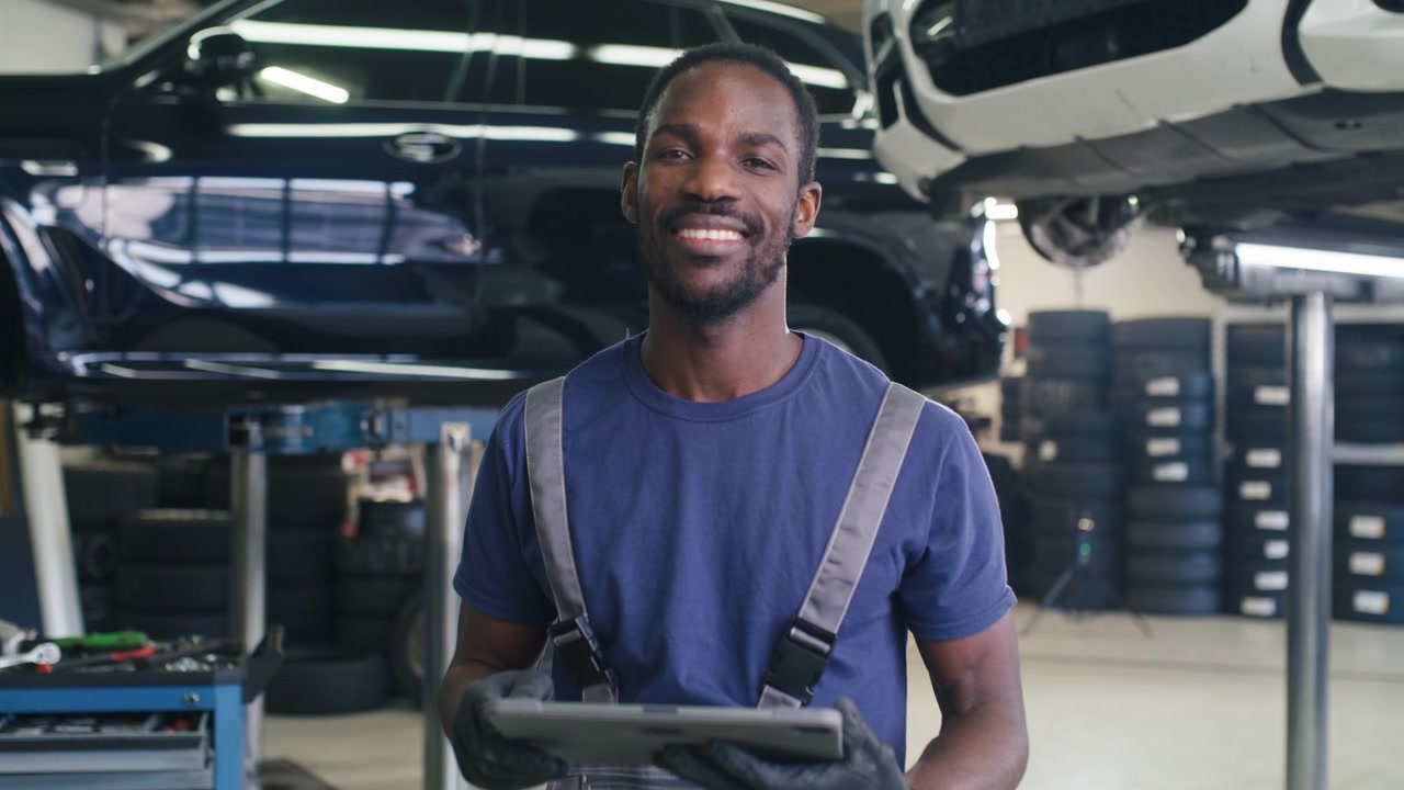 Portrait of african american mechanic using a tablet to diagnose breakdowns check maintenance and