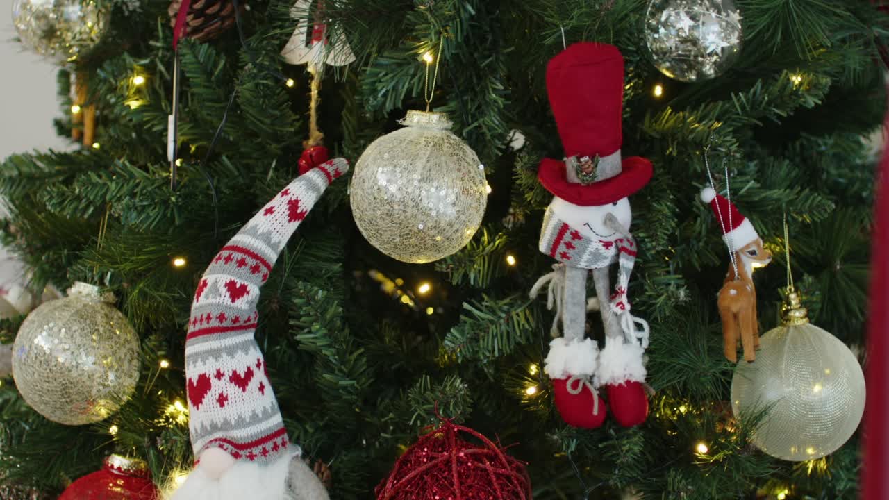 christmas tree adorned with cozy red and gold ornaments and handmade scandinavian decor