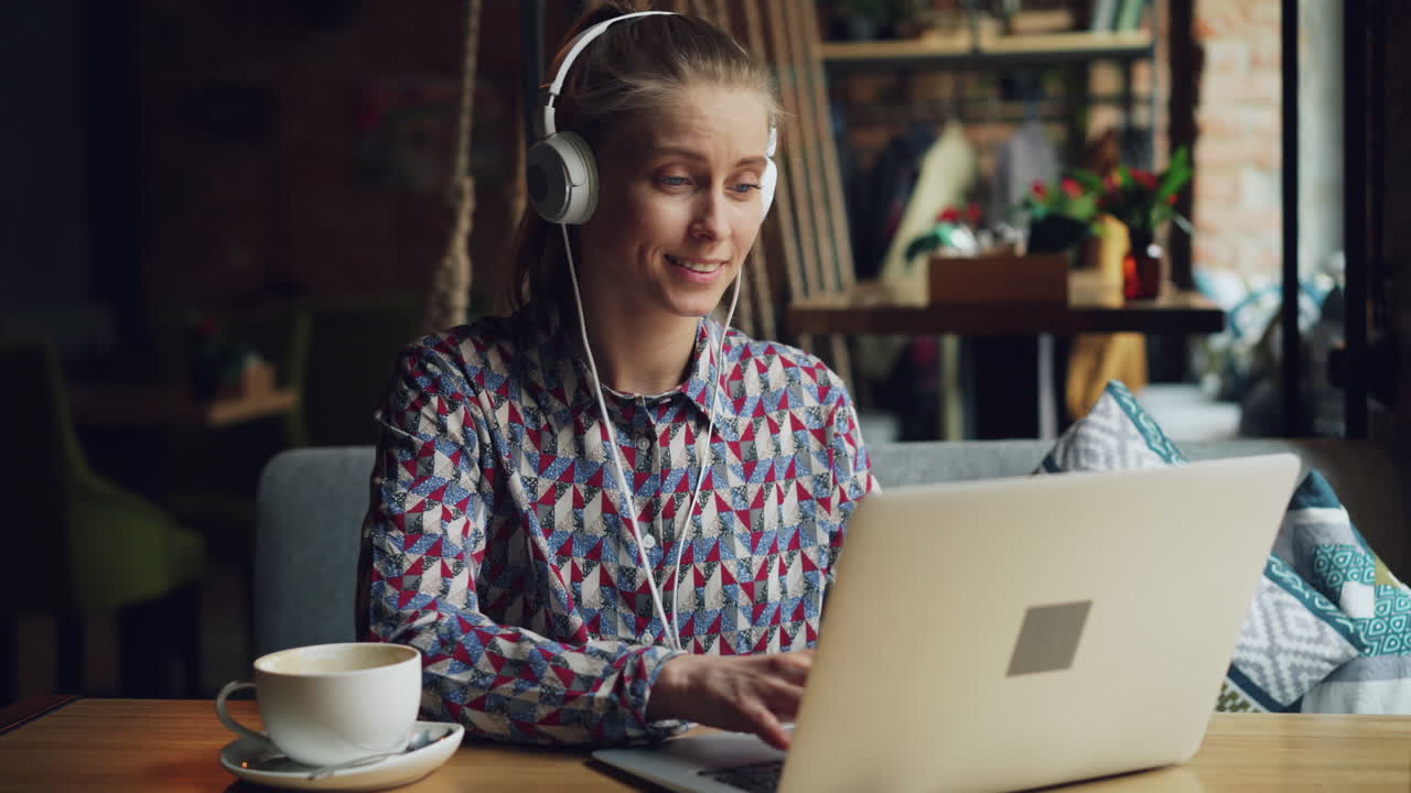 Woman working on laptop in a cafe