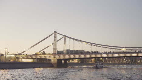 cable-stayed bridge over river at sunset