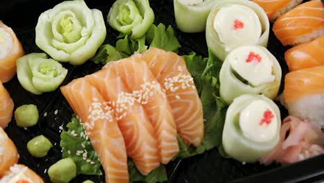 sushi rolls with salmon in plastic tray