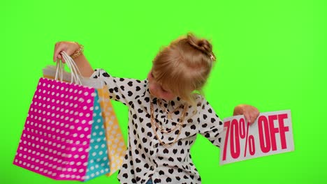 Kid-child-girl-showing-shopping-bags-and-Up-To-70-Percent-Off-inscriptions-banner-text,-Black-Friday