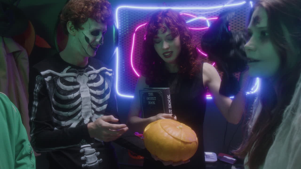 Halloween party with witch, skeleton, and occult book