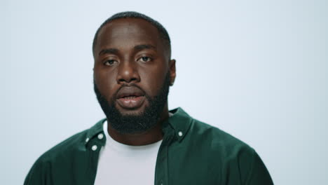 Portrait-of-confused-african-man-asking-question-at-camera-in-studio.