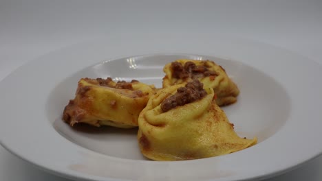 tortelloni with ricotta cheese and spinach on rotating display