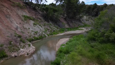 River-valley-in-Estepona,-aerial-drone-low-angle-view