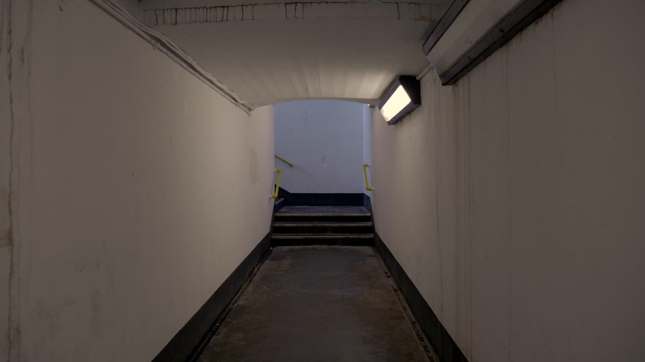 A Tight Hallway With The Lights On In The Train Station Located In Northern Ireland. -wide shot