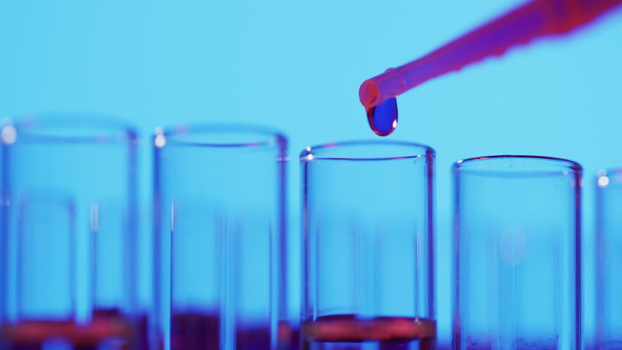 Video of laboratory pipette and test tubes with copy space on blue background