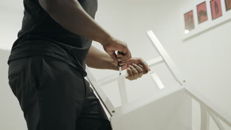 african american man hands keeping chair at kitchen