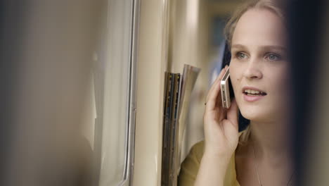 Woman-talking-on-the-phone-in-the-train