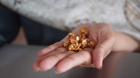 woman holding caramel popcorn