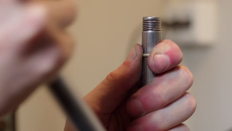 jeweller expanding gold ring in his workshop