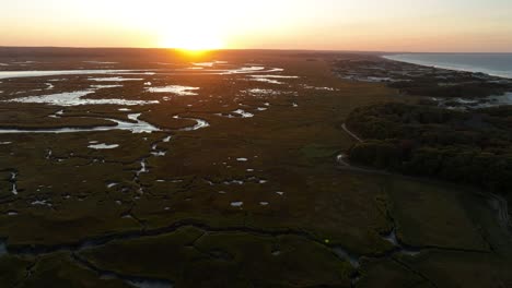 sunset over beautiful salt marsh on cape cod, massachusetts - aerial drone shot