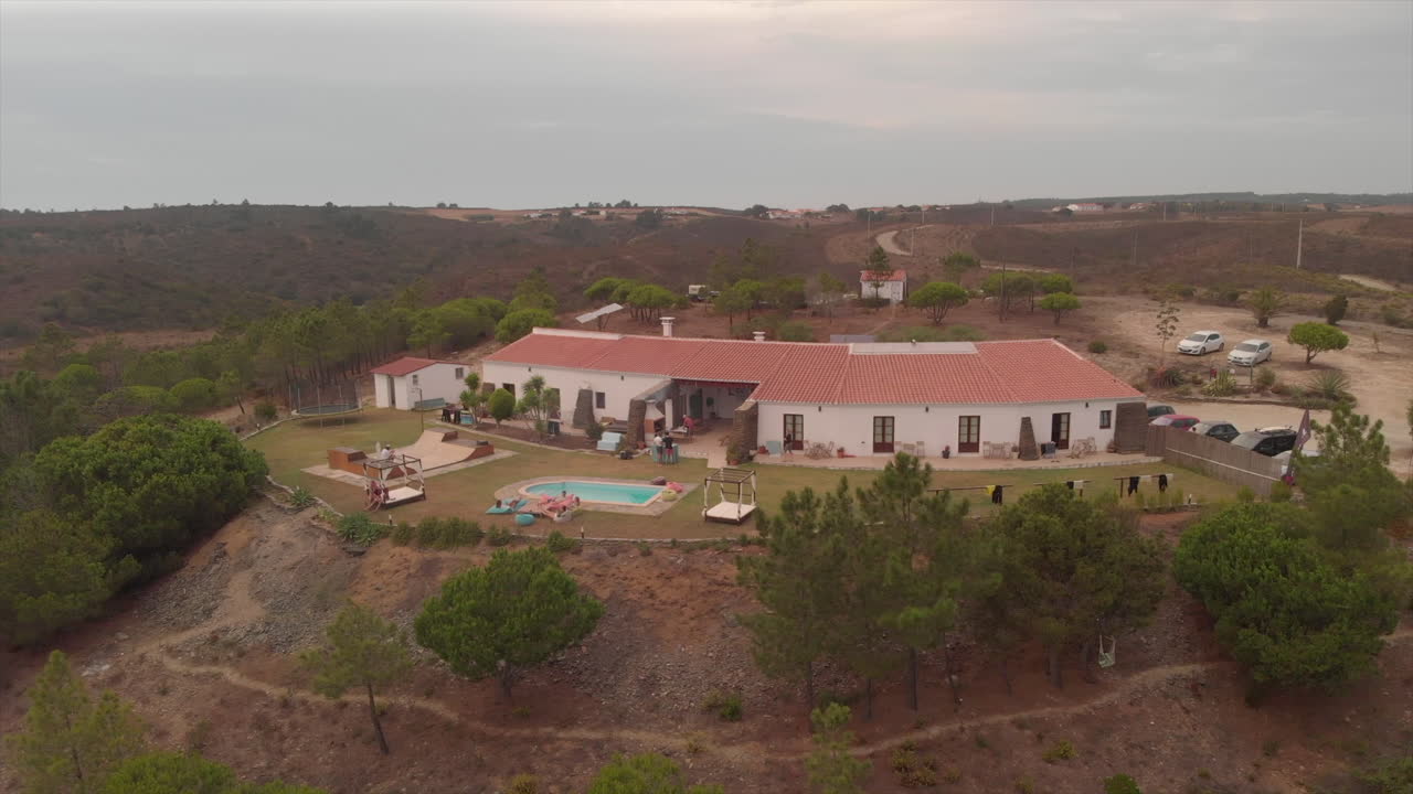Surfers Chilling Outside In A Surf Camp Resort In Algarve, Portugal At Dusk - aerial drone