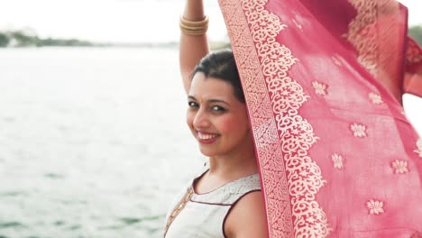 happy portrait of a south asian woman with a red shawl in sydney, australia