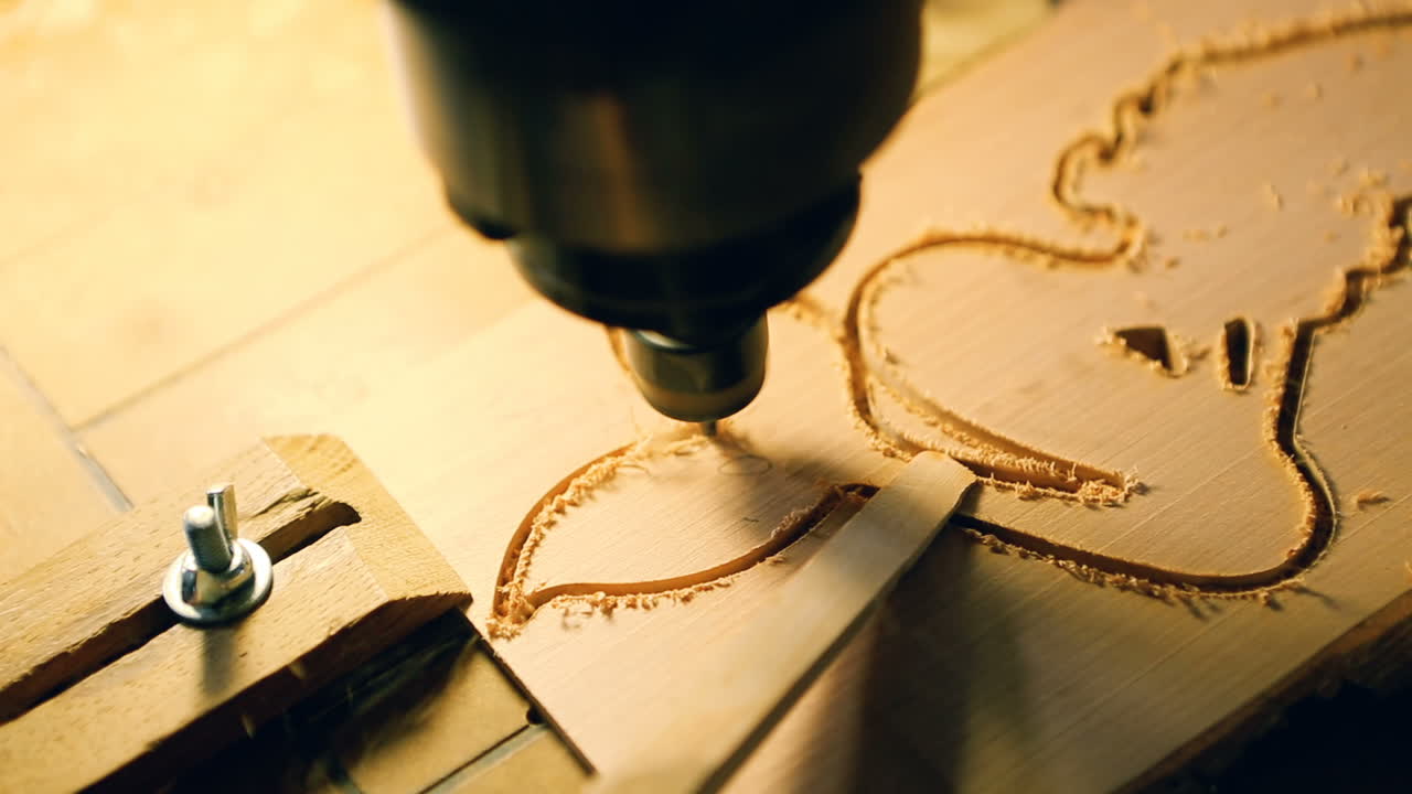 Cnc Drill Is Drilling On The Wooden Plank. In the woodworkers shop the cnc drill is drilling on the wooden plank
