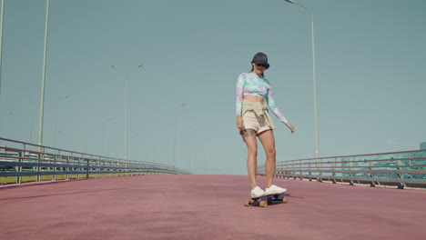 woman skateboarding on a bridge