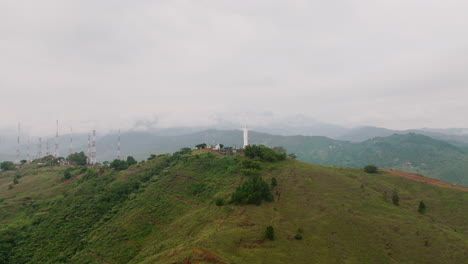 super fast aerial wide to close footage of the cristo rey jesus statue on top of a mountain outside of cali, colombia